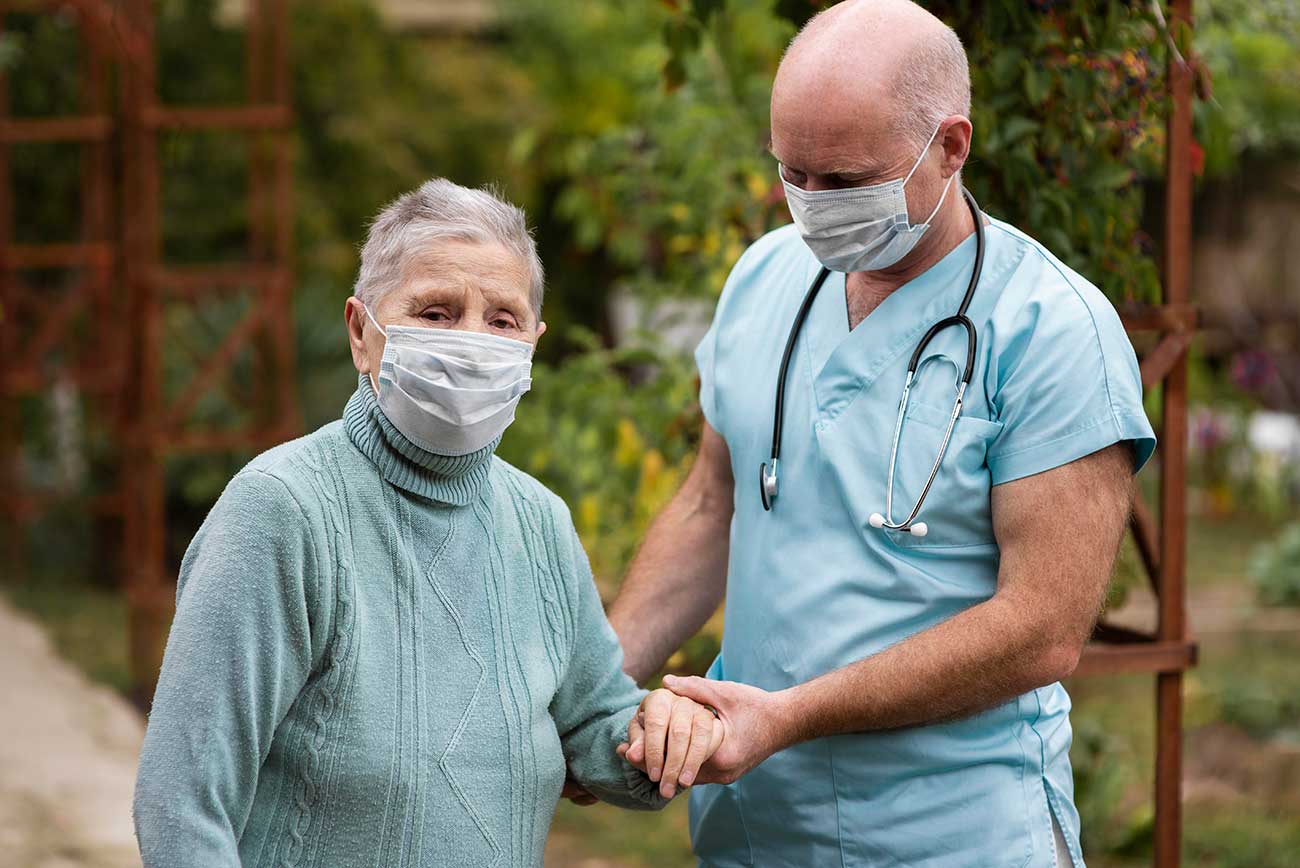 male-nursing-holding-senior-woman-s-hand-help-her-walk